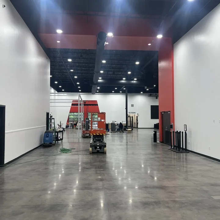 Freshly painted warehouse interior with white walls and a red accent band in Columbia SC