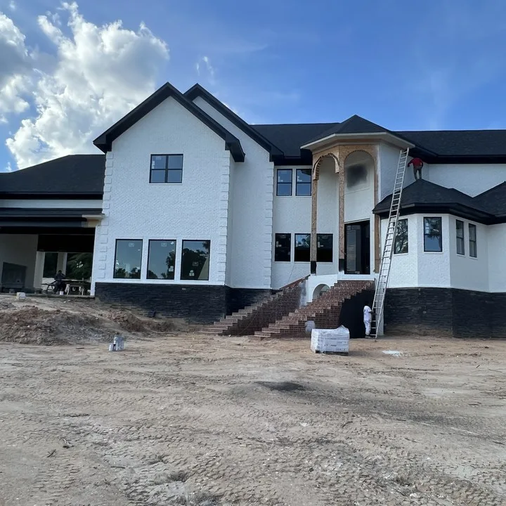 Two-story white brick home in Columbia SC during an exterior painting project