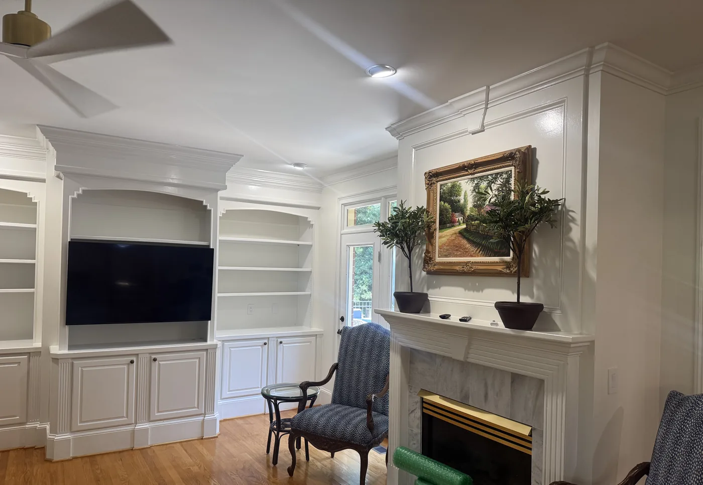 Built-in bookcases, cabinetry, and a fireplace mantel painted white in a Columbia SC home