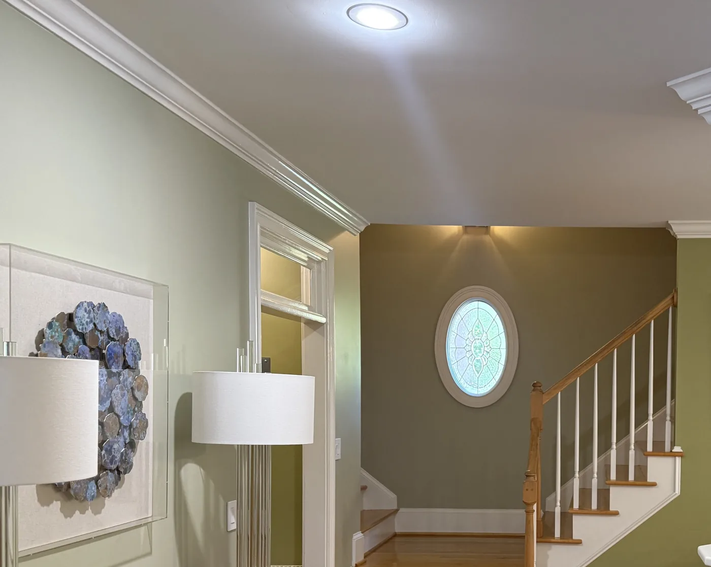 Entry hall and stair painted soft green with white crown molding and trim in Columbia SC