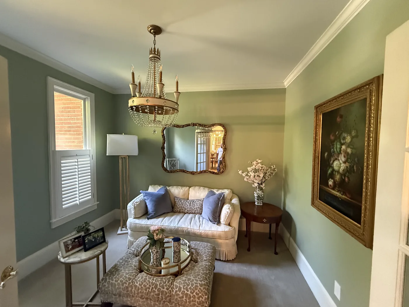 Sitting room painted sage green with white crown molding and window trim in Columbia SC